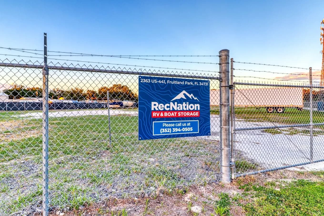 Secure gated truck parking facility entrance with perimeter fencing and 24 hour surveillance in Fruitland Park Florida